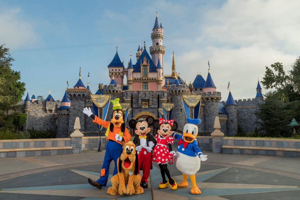 Standing in front of Sleeping Beauty Castle at Disneyland Park, Mickey Mouse, Minnie Mouse and their pals